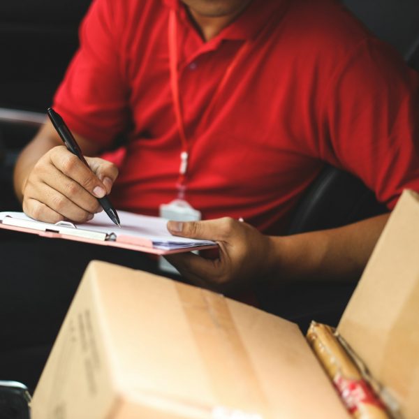 Courier sign shipment document in the car